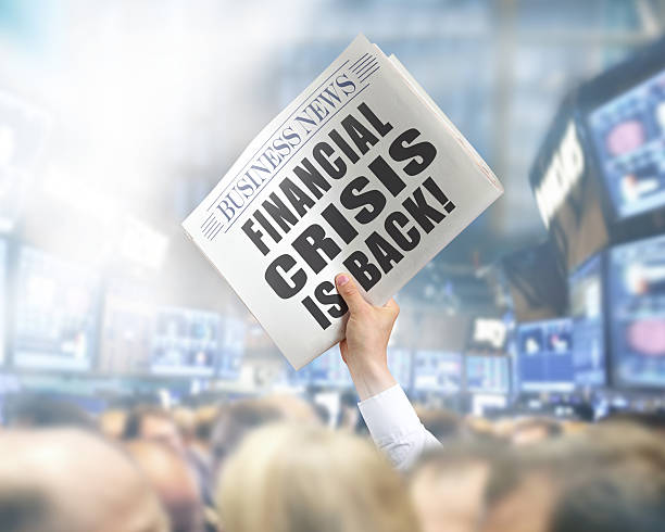 istock Holding Newspaper with Financial Crisis 495760995