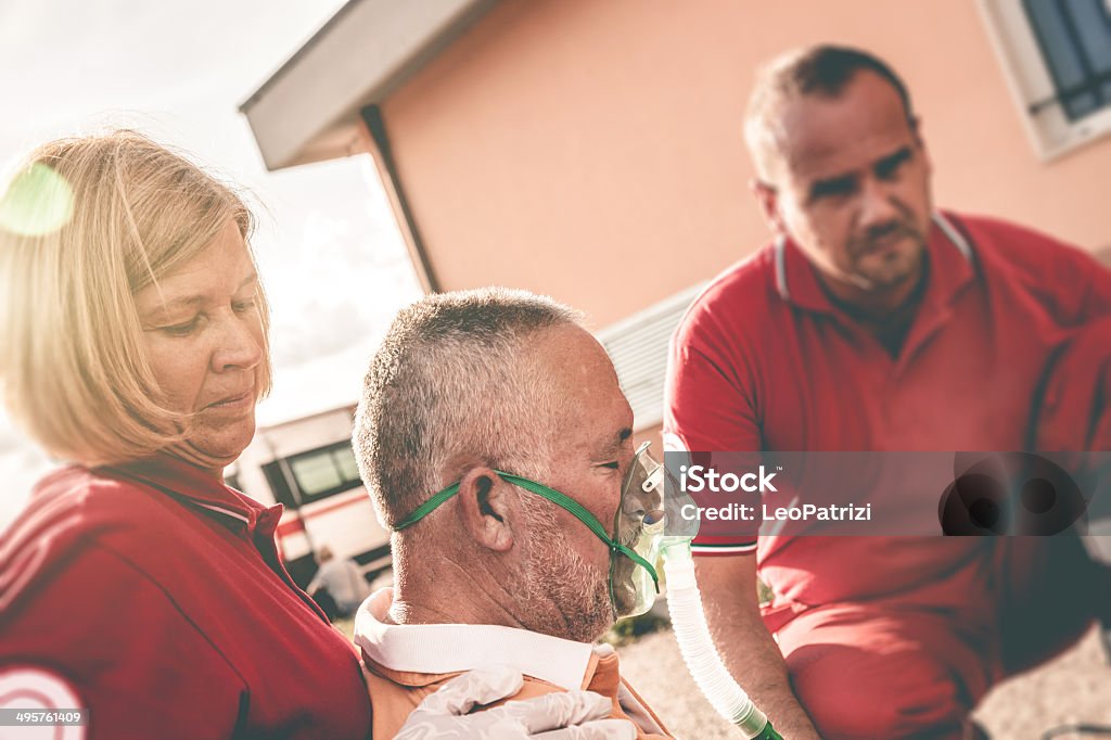 EMT team provide first aid on the street EMT team provide first aid on the street. A Helping Hand Stock Photo