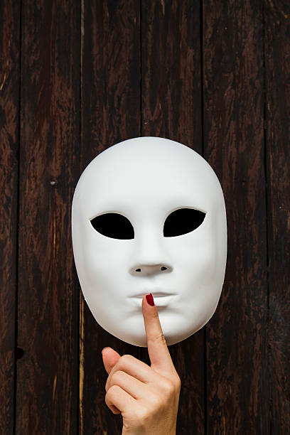 istock Hand making 'shhh' sign on a white mask 495761764