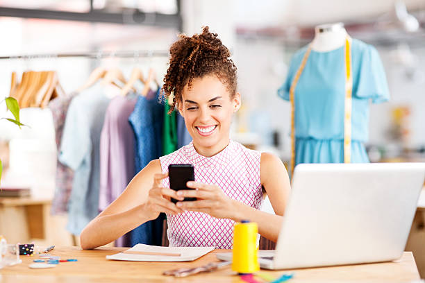 istock Fashion Designer Text Messaging On Smart Phone In Workshop 495762069