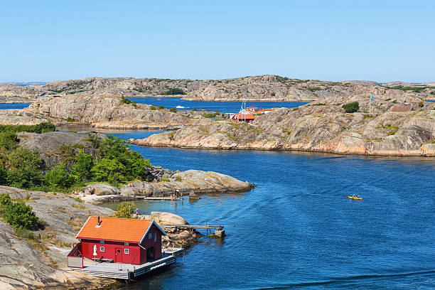 istock Red cottage by the sea 495762395