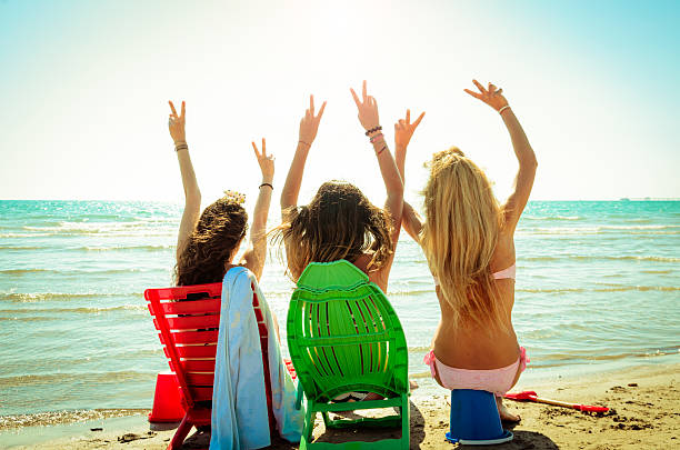Couple friends, Asian women  happy on the beach during at summer vacations; summer holidays, travel, people and vacation concept.