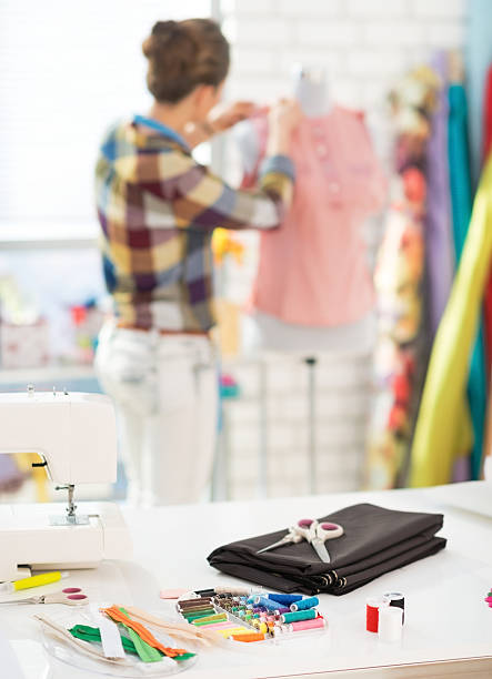 istock closeup on table and seamstress in background 495763971