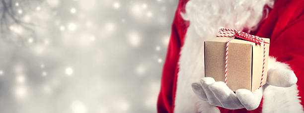 istock Santa Claus holding gift 495771698