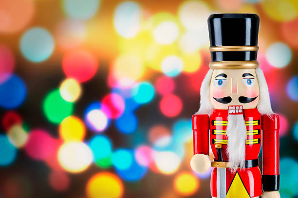 istock Soldier nutcracker statue standing in front of Christmas lights 495771770