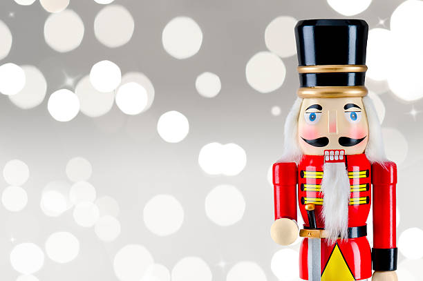 istock Soldier nutcracker statue standing in front of Christmas lights 495771784