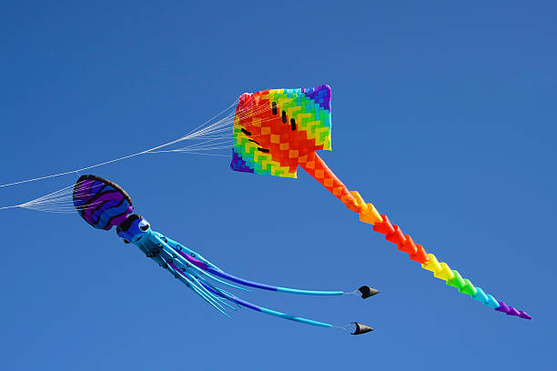 istock Colorful kites against a blue sky 495771856