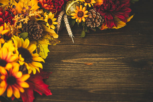 istock Fall themed decorations forming border on wooden background. Thanksgiving celebrations. 495772538