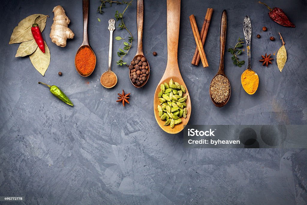 Various Spices on grunge background Various Spices like turmeric, cardamom, chili, bayberry, bay leaf, ginger, cinnamon, cumin, star anise on grunge background with space for your text Spice Stock Photo