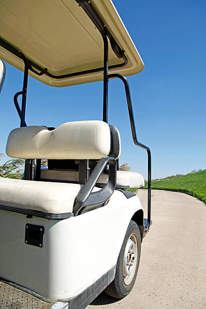 istock White golf carts at the green golf course 495774276