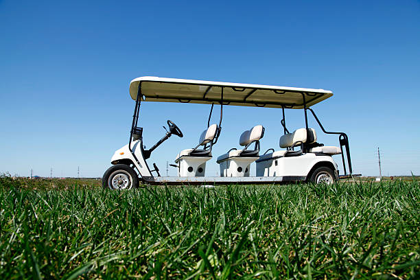 istock White golf carts at the green golf course 495774412