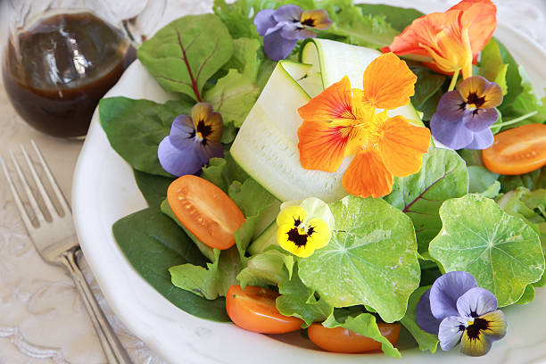 istock Fresh green salad with edible flowers 495776060
