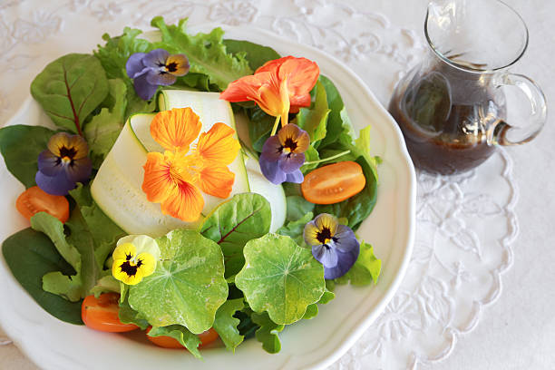 istock Fresh green salad with edible flowers 495776294