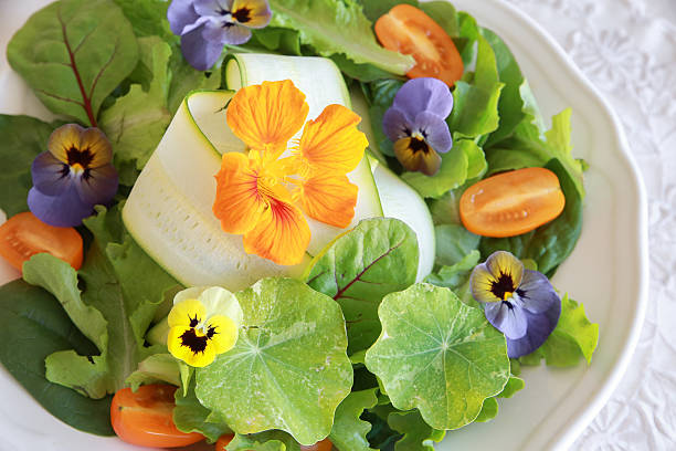 istock Fresh green salad with edible flowers 495776362