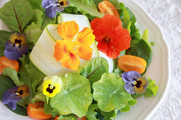 istock Fresh green salad with edible flowers 495776416