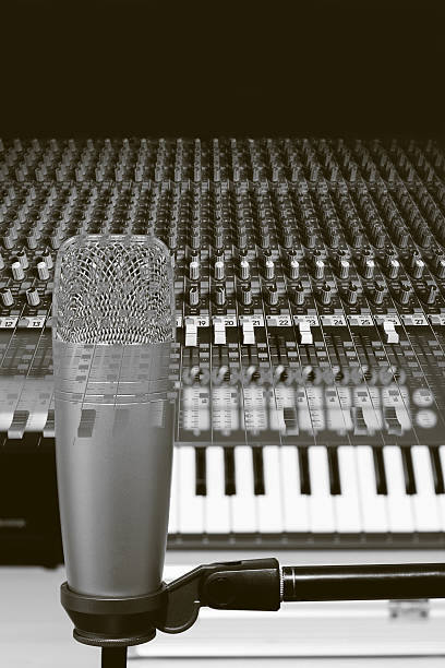 istock double exposure B&W photo of microphone, keyboard  & studio mixer 495777828