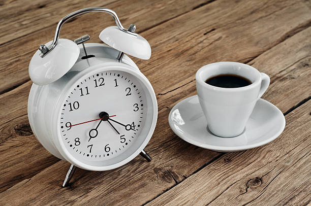 istock white Cup of espresso with an vintage alarm clock 495778830