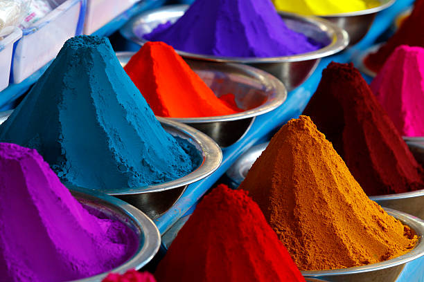 Dye powder stall on Mysore Market, India Stands selling piles and mounds of colorful dye powders for holi festival and other religious uses in Mysore Devaraja Flower Market. The Mysore Flower Market is the perfect place to get fresh local flowers. Its bustling pathways are filled  with roses, brightly coloured marigold and highly scented jasmine. This flower market is one of the city’s main attractions. This is one of the most famous market for flowers and very popular among tourists. mysore stock pictures, royalty-free photos & images