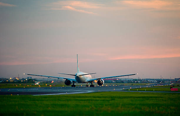 istock passenger plane fly up over take-off runway from airport 495780157