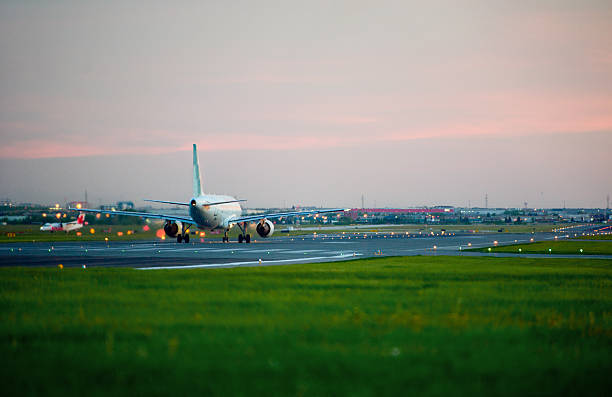 istock passenger plane fly up over take-off runway from airport 495780173