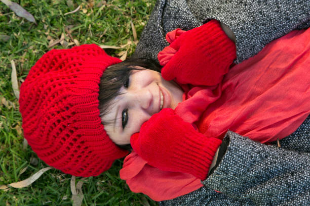 Portrait of a beautiful girl in warm clothes outdoors.