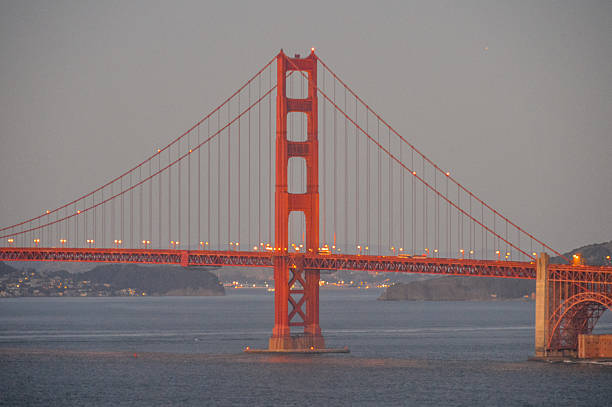 мост золотые ворота-закате - golden gate bridge car san francisco bay san francisco county стоковые фото и изображения