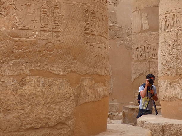 istock Man taking pictures between columns at the hypostyle hall, Karnak. 495783876