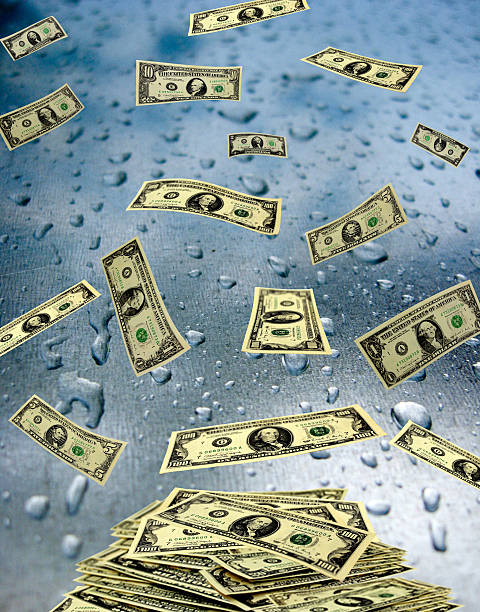 istock dollar banknotes lying on the wet glass 495784167
