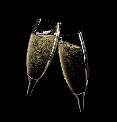 Cheers! Two champagne glasses. Isolated on black background