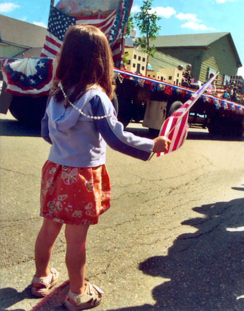 istock Young girl with American flag at parade 495786487