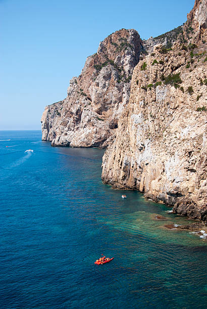 Masua's sea stack daily and some boats in summertime (Sardinia-Italy)