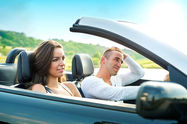 istock Young Couple in a Convertible car 495799652