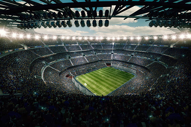 Dramatic soccer stadium upper view View from the upper tribunes to the soccer stadium full of spectators and lenseflares. emergence photos stock pictures, royalty-free photos & images