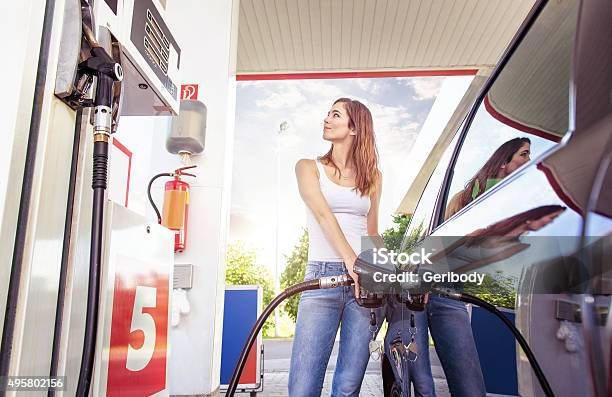 Pretty Young Woman Refuel The Car Stock Photo - Download Image Now - Refueling, Car, Women