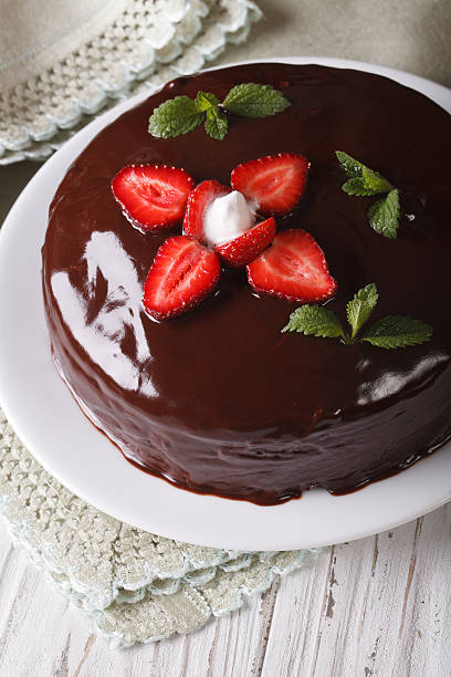 istock Fresh strawberry cake with chocolate topping vertical close-up 495802294