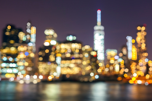 Blurred Manhattan waterfront at night, New York City, USA.