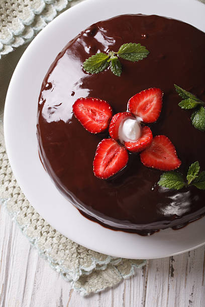 istock cake with strawberries and chocolate close-up. vertical top view 495802500