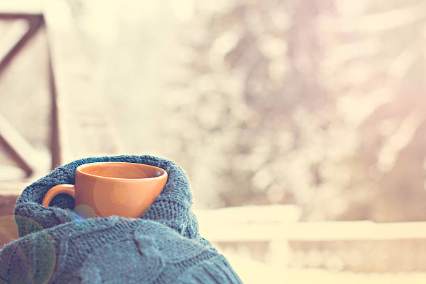 istock Cup with hot drink over winter forest background 495802734