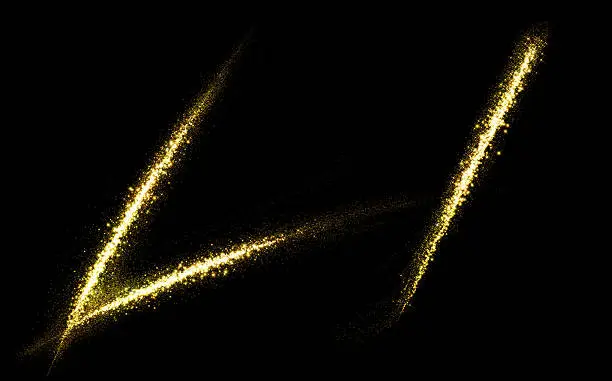 Photo of L letter of gold glittering stars dust flourish tail