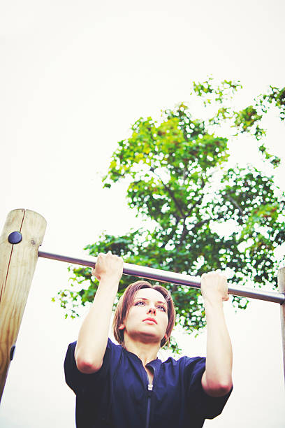 istock Woman Circuit Training in City Park - Pull-ups 495803550