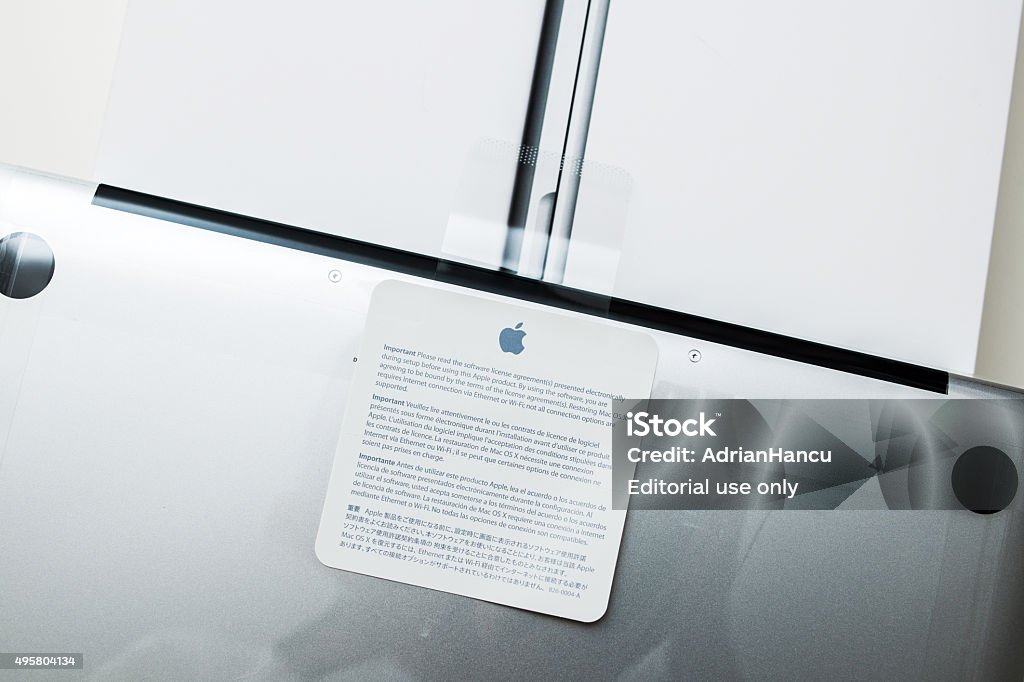 Apple Macbook Pro Retina laptop unboxing security seal London, United Kingdom - January 14, 2015: Recently launched Apple Macbook Pro Retina laptop unboxing security seal with important notice about software agreement on its cartoon box 2015 Stock Photo