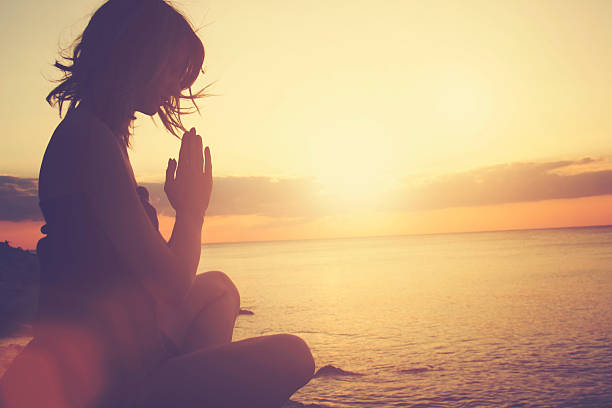 istock Young woman practicing yoga on the beach. 495805646