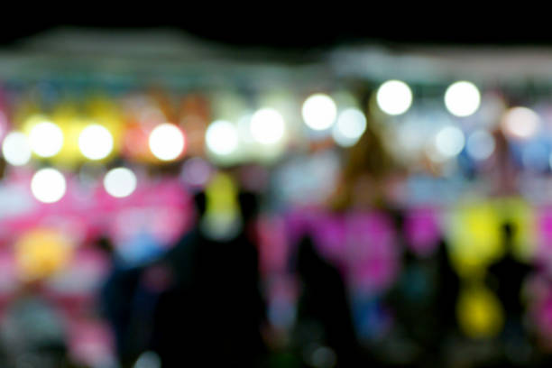 istock Defocused and blurred image of people at night amusement park 495807720