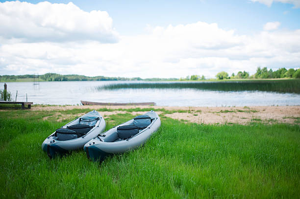 istock Two rubber boats lie on a green grass 495808758