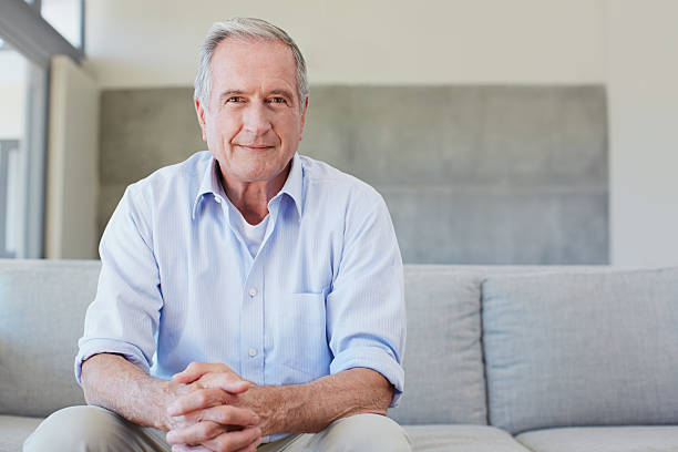 Happy to be in my own space Portrait of a happy senior man sitting on the sofa at homehttp://195.154.178.81/DATA/i_collage/pu/shoots/805858.jpg one senior man only stock pictures, royalty-free photos & images