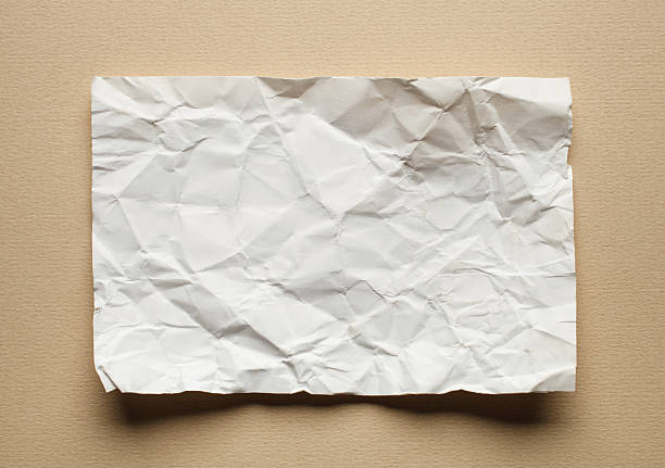 istock Crumpled  white paper card on beige background, place for text 495809192