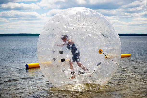 istock the person in a big sphere slides on water 495809226