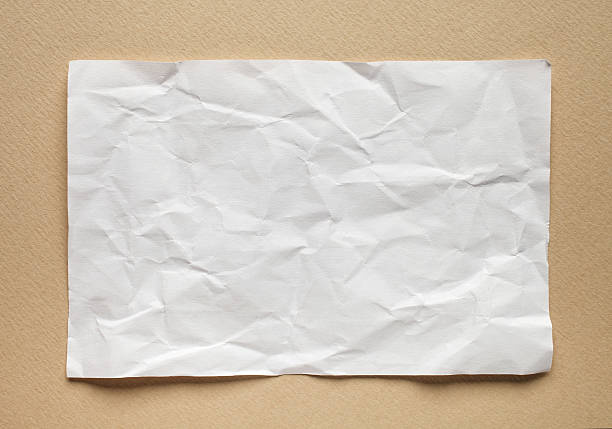 istock Crumpled  white paper card on beige background, place for text 495809230