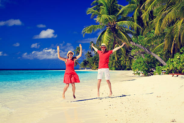 istock Happy couple jumping on the summer beach 495810356