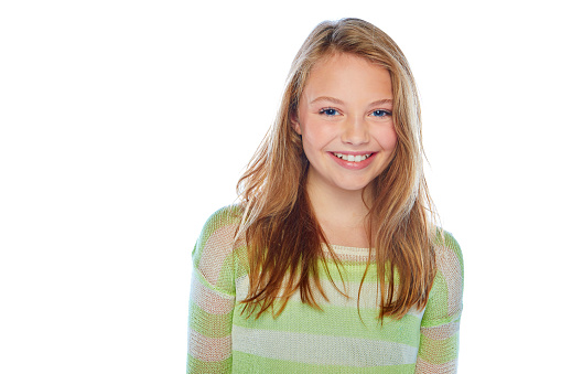 Portrait of beautiful young girl with blondie hair. Confident female wearing blue shirt while posing at grey background. Copy space.